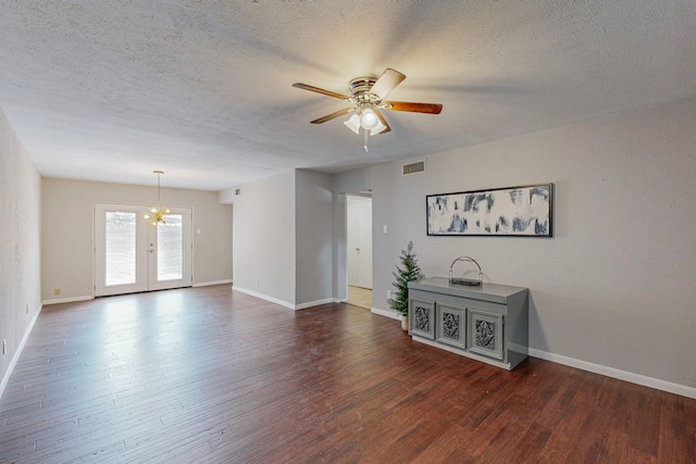 13818 Methuen Green Ln, Dallas, TX 75240 - empty room featuring dark wood finished floors, a textured ceiling, visible vents, and ceiling fan with notable chandelier