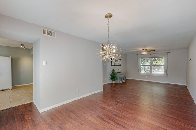 13818 Methuen Green Ln, Dallas, TX 75240 - empty room with baseboards, wood finished floors, visible vents, and ceiling fan with notable chandelier