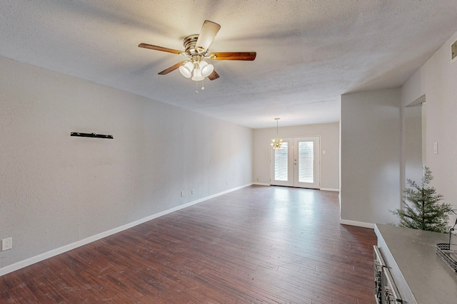 13818 Methuen Green Ln, Dallas, TX 75240 - spare room featuring baseboards, dark wood-style flooring, a textured ceiling, and ceiling fan with notable chandelier