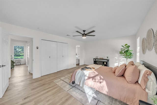 bedroom featuring a closet, connected bathroom, light hardwood / wood-style floors, and ceiling fan