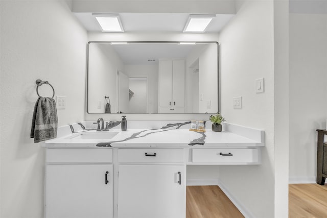 bathroom featuring wood-type flooring and vanity