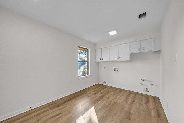 washroom with cabinets, washer hookup, gas dryer hookup, and light hardwood / wood-style floors