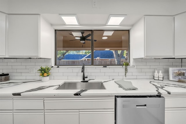 kitchen featuring white cabinets, sink, tasteful backsplash, and stainless steel dishwasher