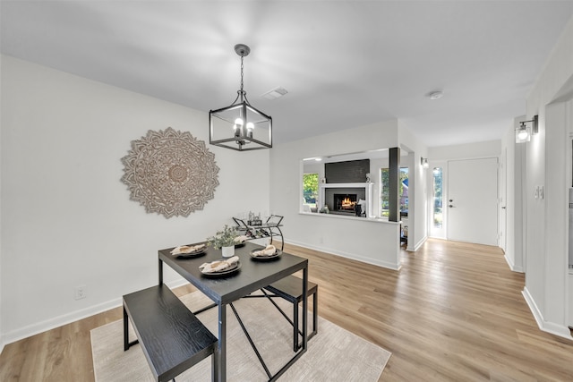 dining room with a chandelier and light hardwood / wood-style floors