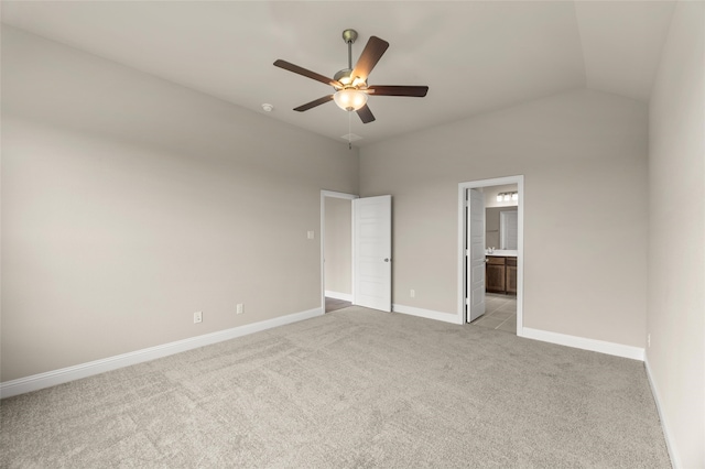 unfurnished bedroom with light carpet, lofted ceiling, ensuite bath, and ceiling fan