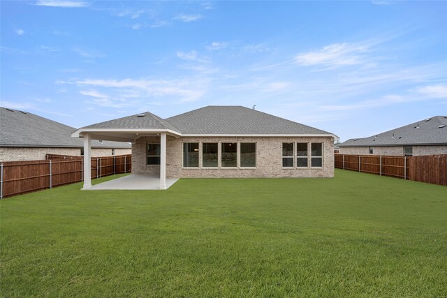 rear view of property with a patio area and a yard