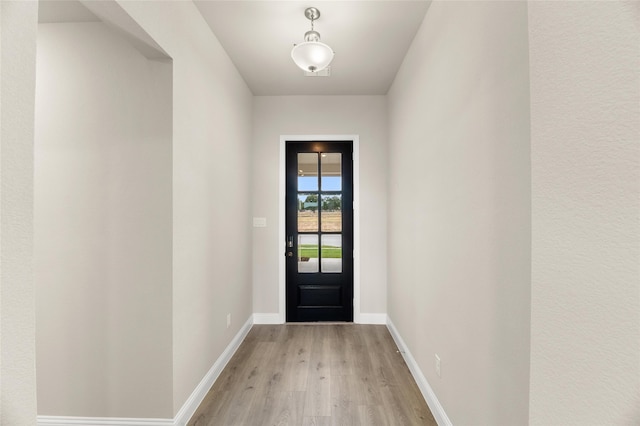 doorway to outside with light wood-type flooring