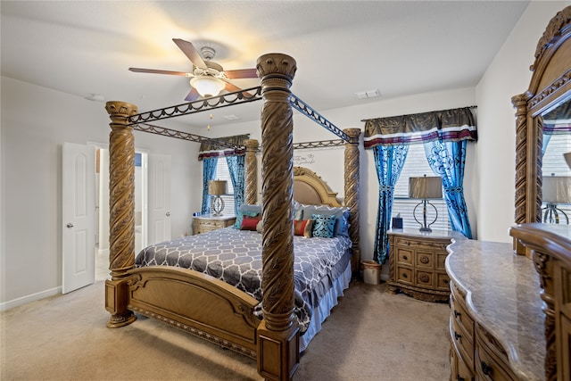 bedroom featuring baseboards, a ceiling fan, visible vents, and light carpet