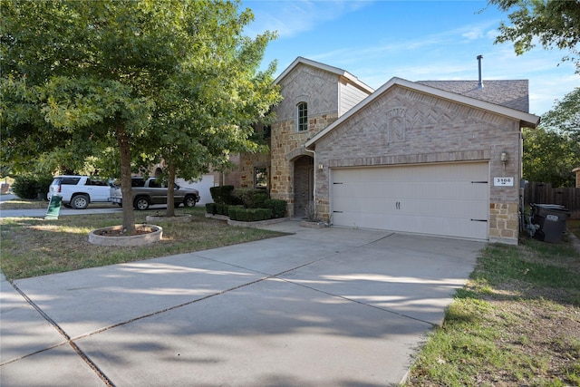 view of front facade with concrete driveway, an attached garage, and stone siding