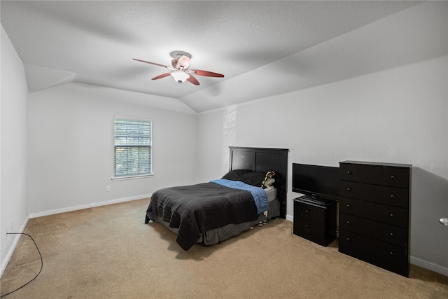 bedroom featuring lofted ceiling, a ceiling fan, baseboards, and light carpet