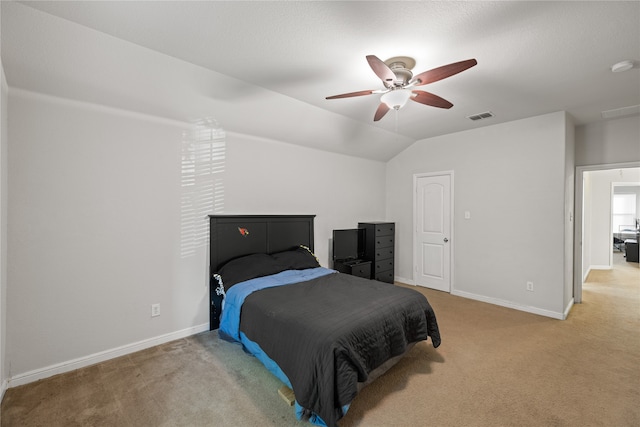 bedroom featuring lofted ceiling, light colored carpet, visible vents, and baseboards