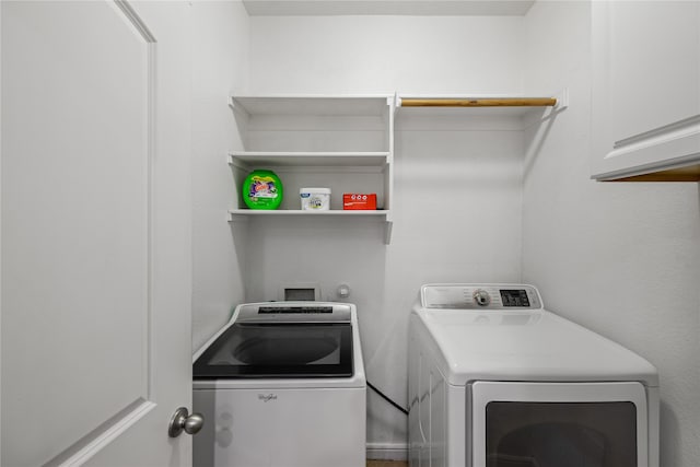 laundry room with cabinet space and washing machine and clothes dryer