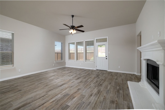 unfurnished living room with ceiling fan and hardwood / wood-style flooring