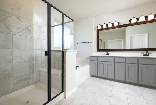 bathroom featuring independent shower and bath, tile patterned flooring, and vanity