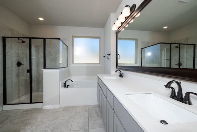 bathroom featuring shower with separate bathtub, tile patterned floors, and vanity