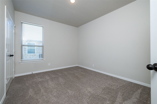 unfurnished room featuring dark carpet