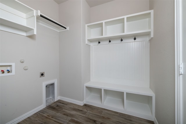 interior space with gas dryer hookup, dark wood-type flooring, electric dryer hookup, and hookup for a washing machine