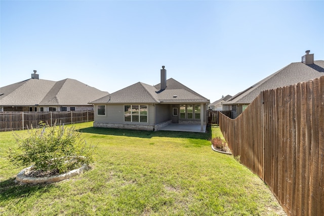 back of house featuring a yard and a patio area