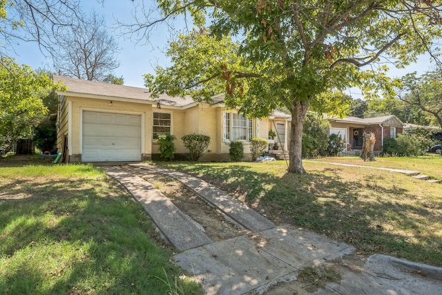 ranch-style house featuring a garage and a front lawn