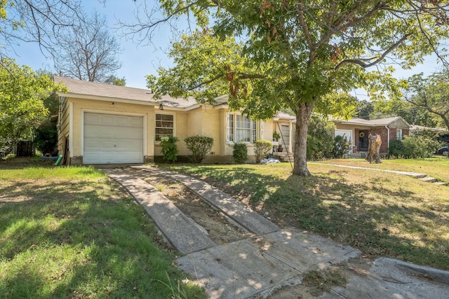 view of front of property featuring driveway, a front yard, and a garage