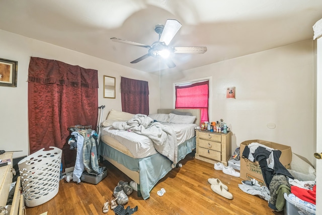 bedroom with ceiling fan and hardwood / wood-style floors