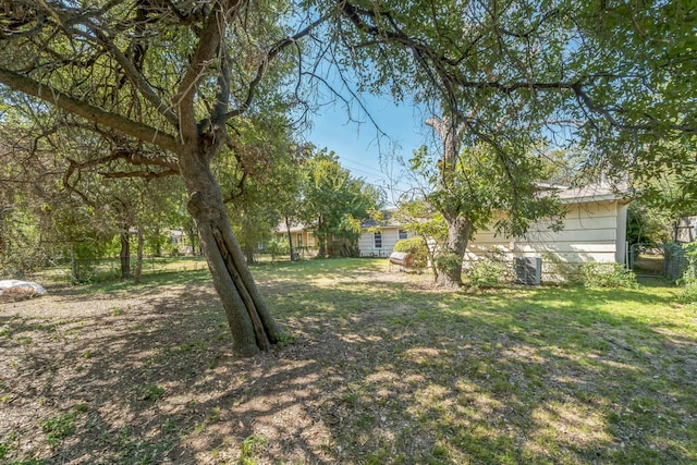 view of yard featuring cooling unit and fence