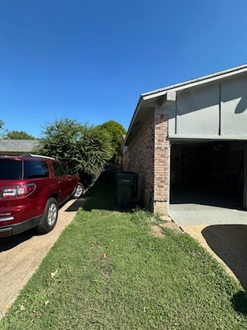 view of property exterior with a lawn