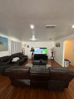 living room featuring wood-type flooring and a textured ceiling