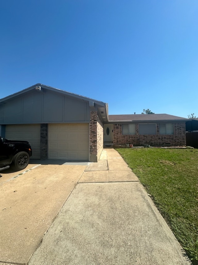 single story home with a garage and a front yard