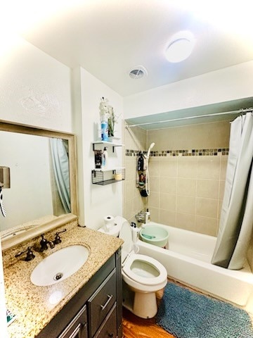 full bathroom with shower / tub combo with curtain, wood-type flooring, vanity, and toilet