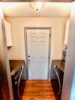 laundry area with separate washer and dryer and light hardwood / wood-style flooring