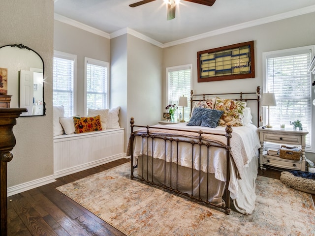 bedroom with ceiling fan, dark hardwood / wood-style floors, ornamental molding, and multiple windows