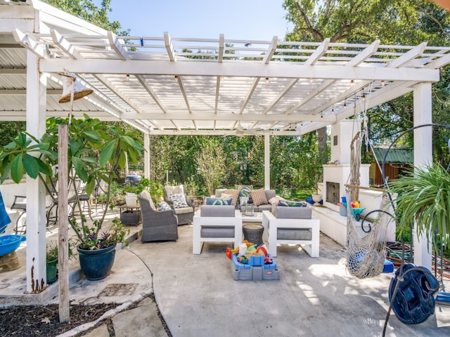 view of patio / terrace with an outdoor living space with a fireplace and a pergola