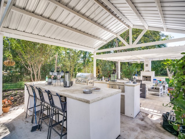 view of patio with an outdoor bar, exterior kitchen, and a grill