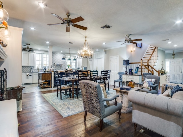 living room featuring a textured ceiling, ceiling fan with notable chandelier, crown molding, and hardwood / wood-style floors