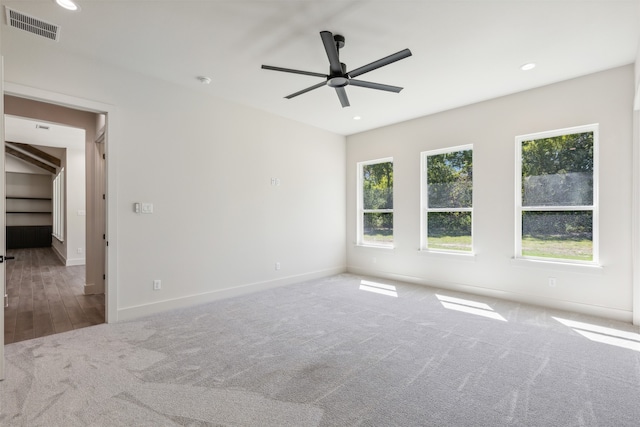 empty room with ceiling fan and hardwood / wood-style floors