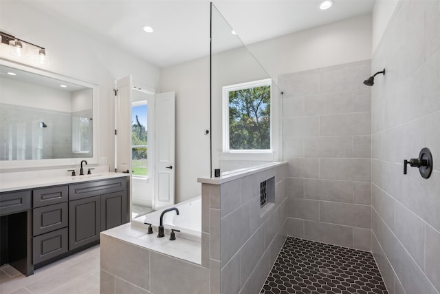 bathroom featuring vanity, plus walk in shower, and tile patterned flooring