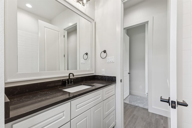 bathroom with vanity and hardwood / wood-style flooring