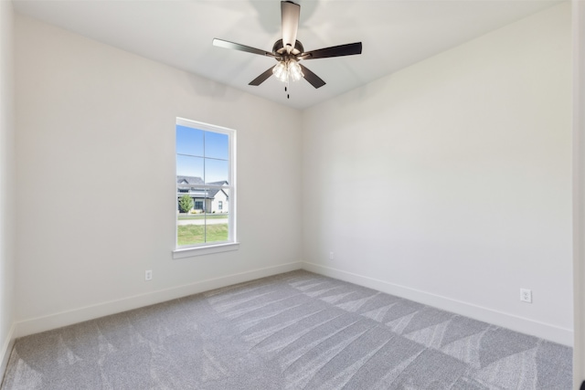 empty room featuring carpet flooring and ceiling fan