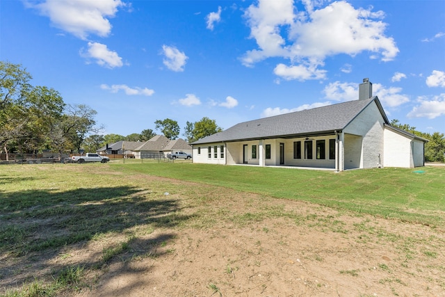 rear view of house with a lawn