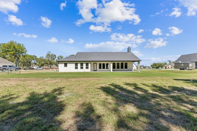 back of property with a yard