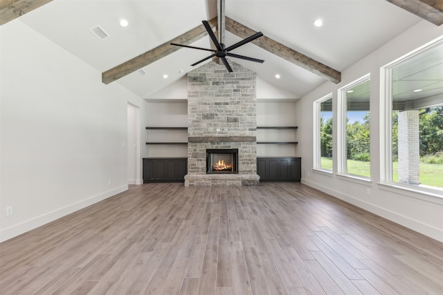 unfurnished living room featuring beam ceiling and light hardwood / wood-style floors