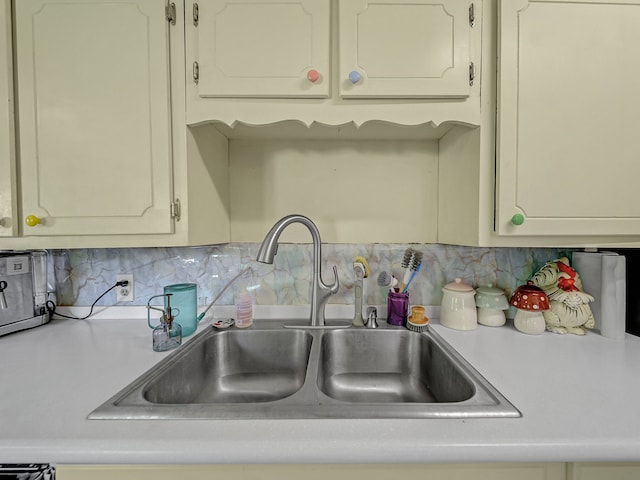 kitchen featuring decorative backsplash and sink