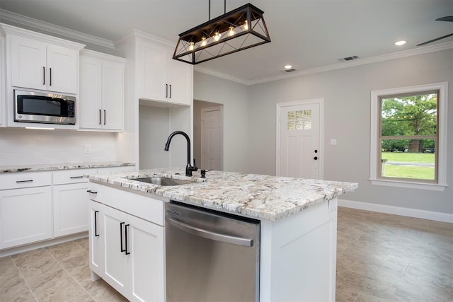 kitchen with stainless steel appliances, white cabinets, and a kitchen island with sink