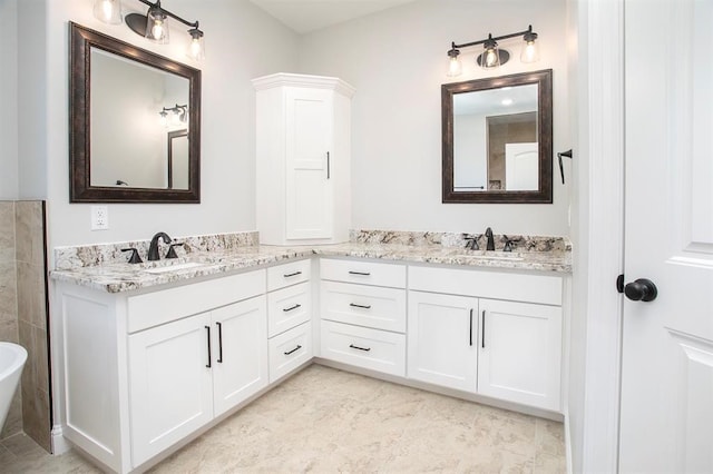 bathroom with vanity, a bathtub, and tile patterned floors