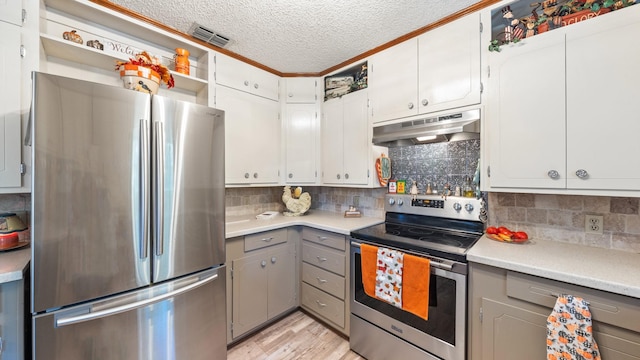 kitchen with white cabinets, decorative backsplash, gray cabinets, a textured ceiling, and appliances with stainless steel finishes