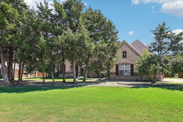 obstructed view of property featuring a front yard