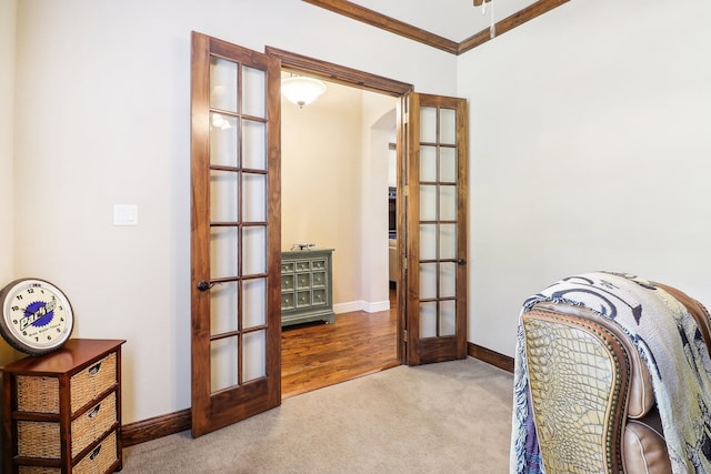 office with ornamental molding, hardwood / wood-style flooring, and french doors