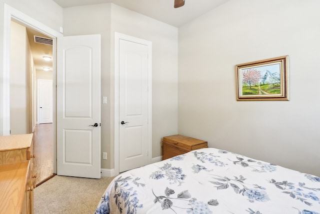 bedroom with light carpet and ceiling fan