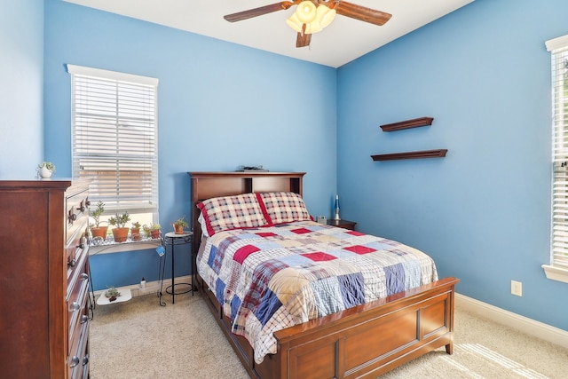 bedroom featuring light carpet and ceiling fan